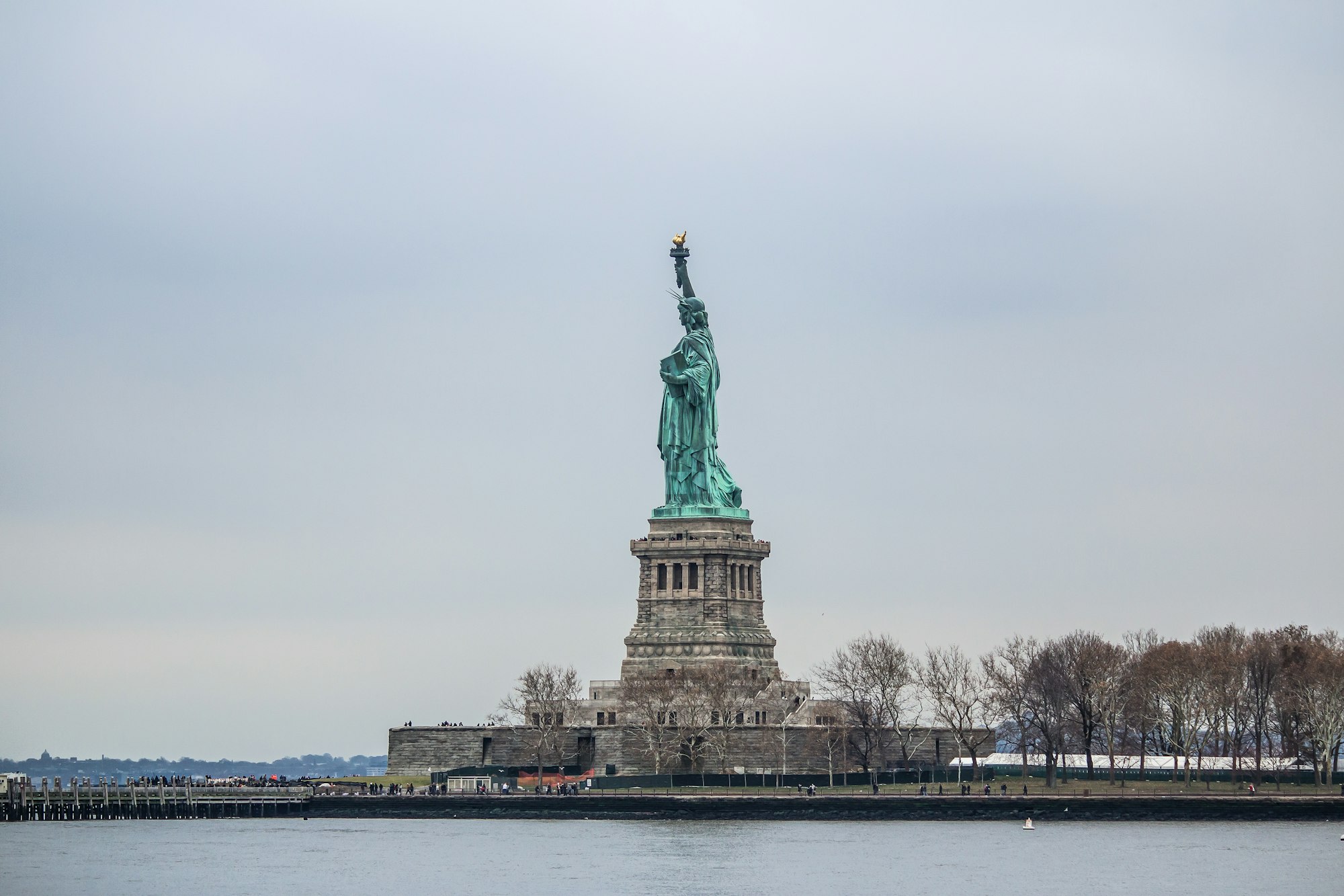 The Statue of Liberty and its pedestal on Liberty Island, seen from the water
